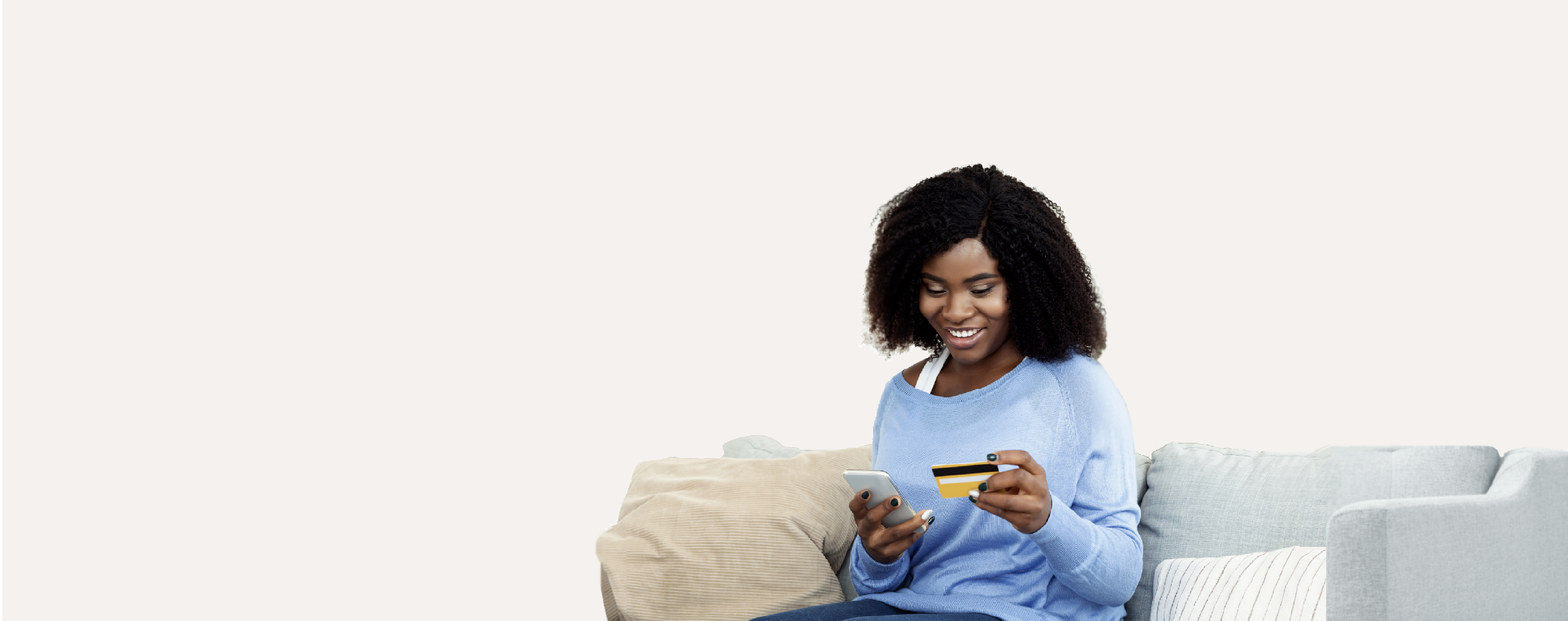 Woman sitting on couch with phone and card