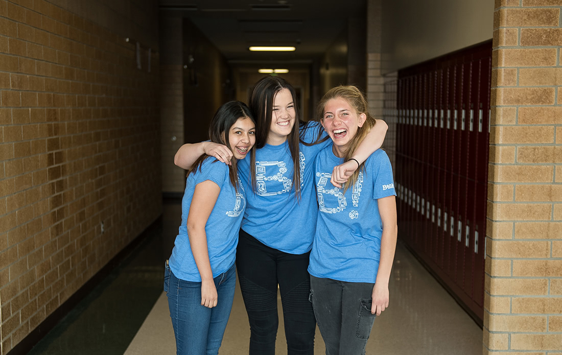 Three students in school hallway